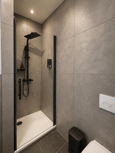a shower with a glass door in a bathroom at FeWo- Room Rental Rheine in Rheine