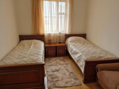 two beds in a room with a window at Gayane & Khikar B&B in Chʼiva