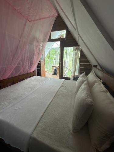 a large bed with pillows in a room at MOYE MOYE Ella in Ella