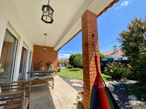 a porch with a brick pillar and a bench at Charming House in SINTRA with Private Pool in Sintra