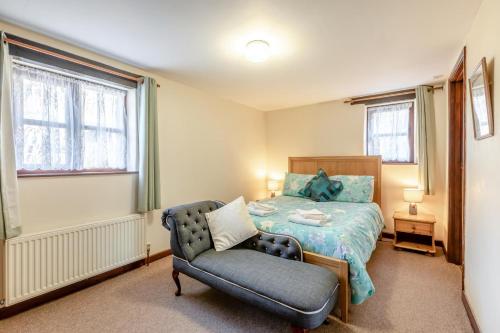 a bedroom with a bed and a chair in it at 4 Bed in Westward Ho oc-n1623 in Westward Ho