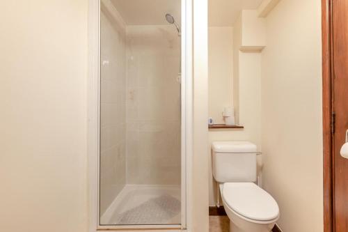 a bathroom with a toilet and a glass shower at 4 Bed in Westward Ho oc-n1623 in Westward Ho