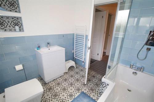 a bathroom with a toilet and a sink and a shower at 4 Bed in Swansea oc-hh682 in Parkmill