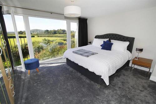a bedroom with a bed and a large window at 4 Bed in Swansea oc-hh682 in Parkmill
