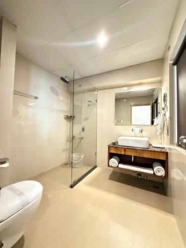a bathroom with a toilet and a sink and a shower at Crown Himalaya in Leh