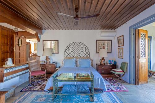 a bedroom with a bed with a wooden ceiling at Villa Mitzela in Amaliapoli