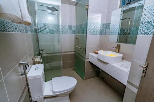 a bathroom with a toilet and a sink and a shower at The Shann Hotel Danang in Danang