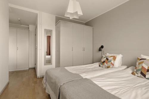 a bedroom with a large white bed in it at The Nooq Alvik - Hotel & Studios in Stockholm