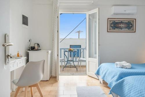 a bedroom with a bed and a view of a balcony at Angeliki Pension in Katapola