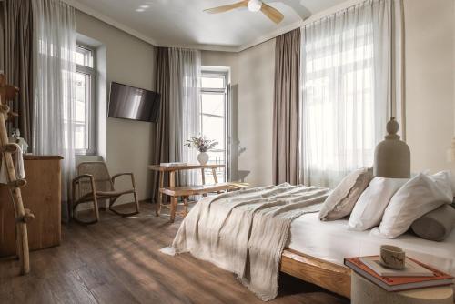 a bedroom with a large bed and a table at Ederlezi Boutique Hotel in Athens