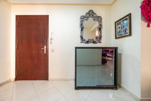 a room with a mirror and a glass door at First Line Beach & Free Parking in Tangier