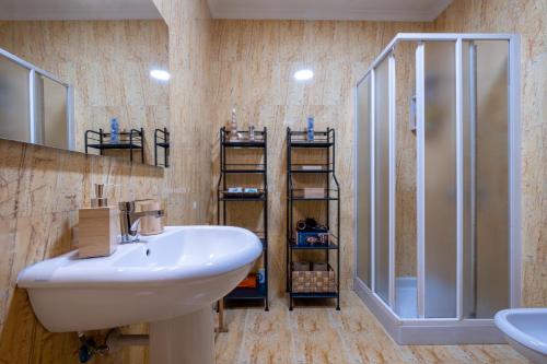 a bathroom with a sink and a shower at FamilyHub - EcoHost - Spacious 3-bedroom apartment for 8 people with AC and parking near Porto and the beaches in Senhora da Hora