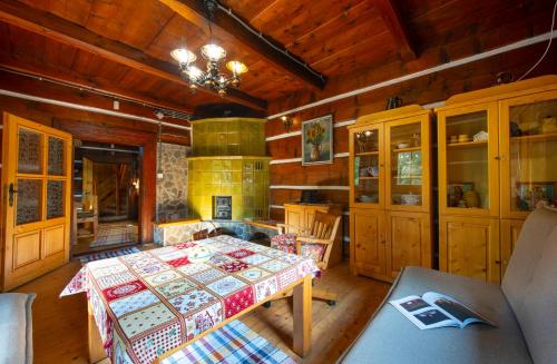 a dining room with a table and a fireplace at Chata a Chalety Starý mlyn in Veľká Franková
