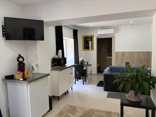 a room with a kitchen and a living room at Hôtel-Restaurant Belle'man in Longevelle-sur-Doubs