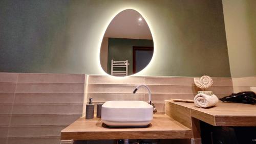 a bathroom with a sink and a mirror at Villa Elizabeth Apartments in Ouranoupoli