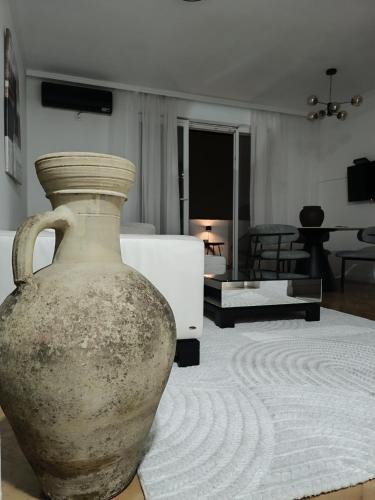 a large vase sitting on the floor in a living room at White Lounge Haustor in Podgorica