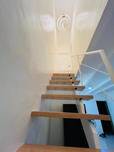 a staircase in a house with wooden steps at Casa Serenity Transient House in General Trias