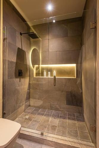 a shower with a glass door in a bathroom at Luxury Beachfront 4BR PH in Bahia Soliman in Balcheil