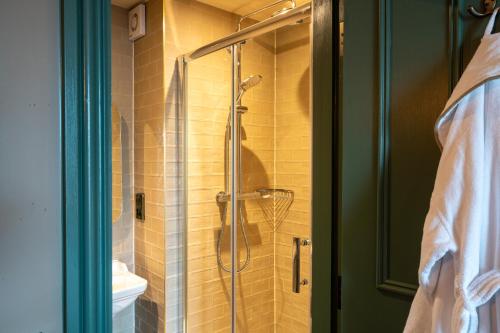 a shower with a glass door in a bathroom at The Rising Sun - Pensford in Pensford