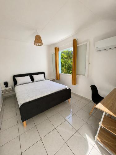 a bedroom with a bed and a window at Chambres chez l'habitant in Saint-Paul
