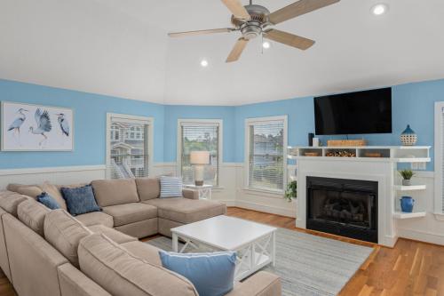 a living room with a couch and a fireplace at Heron Landing in Corolla