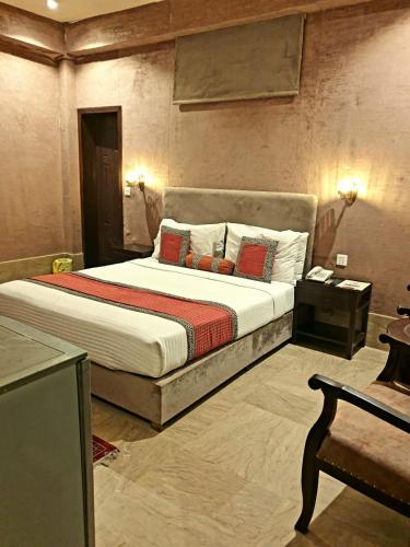 a bedroom with a large bed in a room at Shelton Hotel Johar Town Lahore in Lahore