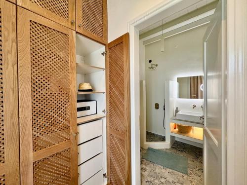 a walk in closet with a wooden door at Patmos Cliff House in Patmos