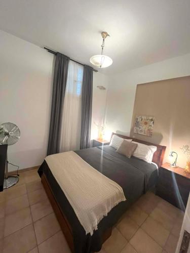 a bedroom with a large bed and a window at Castelli Retreat in Spetses