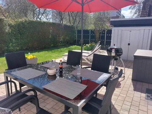 a table and chairs with an umbrella on a patio at Haus Schwalbennest in Dahme
