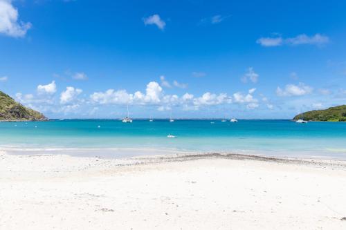 a view of a beach with boats in the water at Anse Marcel Cove Suites in Anse Marcel 