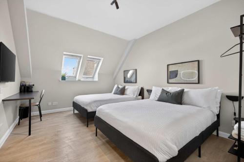 a bedroom with two beds and a desk in it at Sanctuary Hotel - En Suite Rooms in Aberdeen