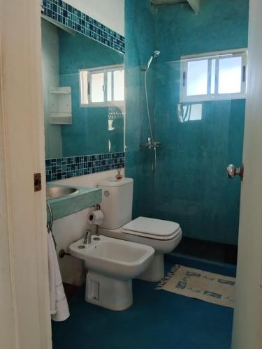 a bathroom with a toilet and a sink at Bosque del Este in Balneario Buenos Aires