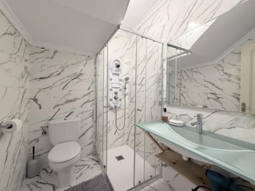 a bathroom with a toilet and a sink at Apartamento La Bruma 30807 in Somo