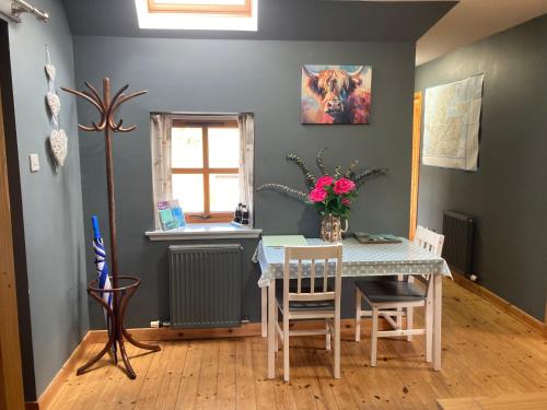 a dining room with a table and a window at Jakels Rest in Lairg