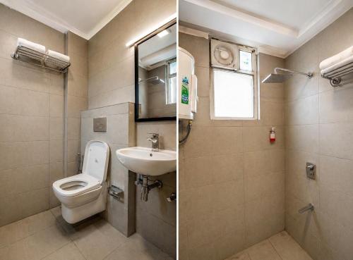 a bathroom with a toilet and a sink at Hotel Konark Inn in Indore
