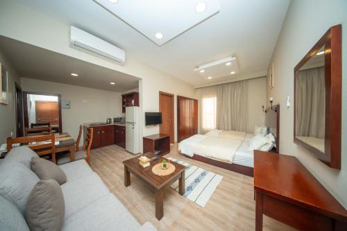 a hotel room with a bed and a living room at The Home Dreamland in 6th Of October
