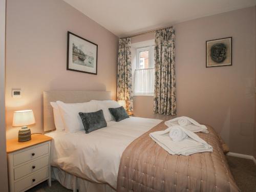 a bedroom with a bed and a window at The Old China Shop in Ludlow