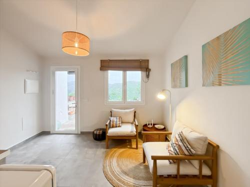a living room with a couch and a chair at Hacienda Gallego in Málaga