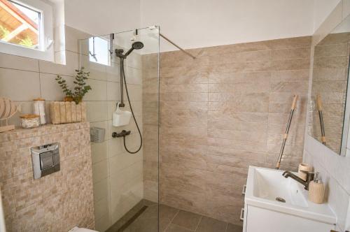 a bathroom with a shower and a sink at Zen Retreat House Sovata in Sovata
