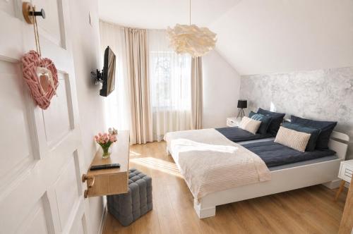 a bedroom with a large bed with a blue blanket at Zen Retreat House Sovata in Sovata