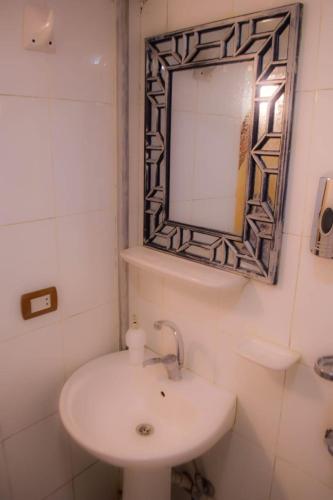 a bathroom with a sink and a mirror at 1Water Lily in Luxor