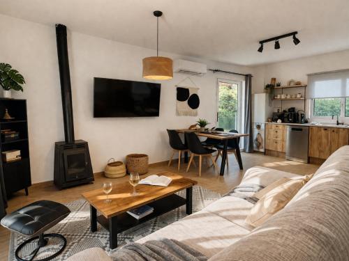 a living room with a couch and a table at Hauzify I Casa Olivella B in Olivella