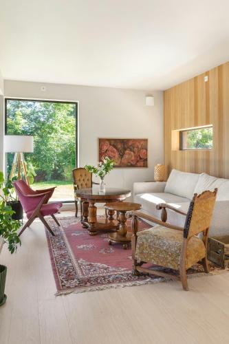 a living room with a couch and a table at Modern Cabin With Panoramic Views in Hønefoss