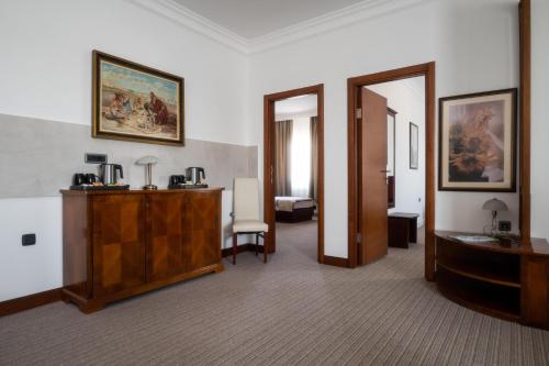 a hotel room with a hallway with a desk and a mirror at Hotel Mio City in Kula