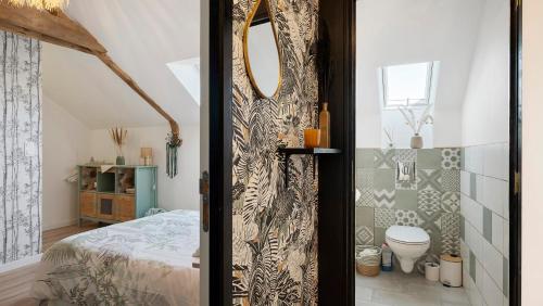 a door leading to a bedroom with a bed at Gîte Les Légendes du Plessis in Iffendic
