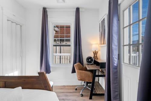 a bedroom with a bed and a desk and a window at Boston First floor condo in Framingham