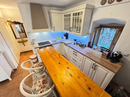 a kitchen with a wooden table and some chairs at Artisana Silba in Silba