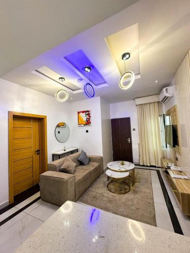a living room with a couch and a table at Supreme Apartments in Ibadan