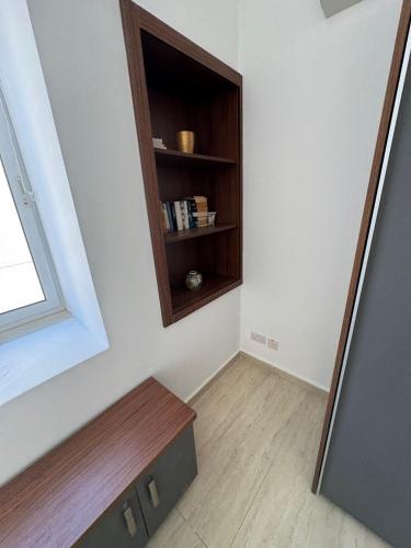 a room with a mirror and a book shelf at Valletta Waterfront Hideaway in Il-Furjana