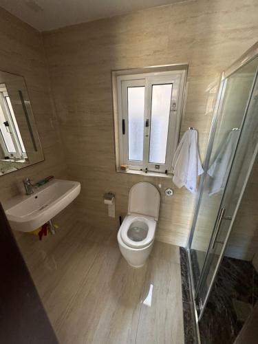 a bathroom with a toilet and a sink at Valletta Waterfront Hideaway in Il-Furjana